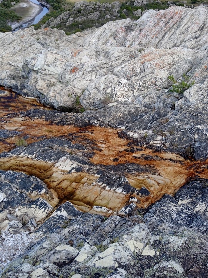 Explore intricate rock layers with unique textures and colors in a natural setting.